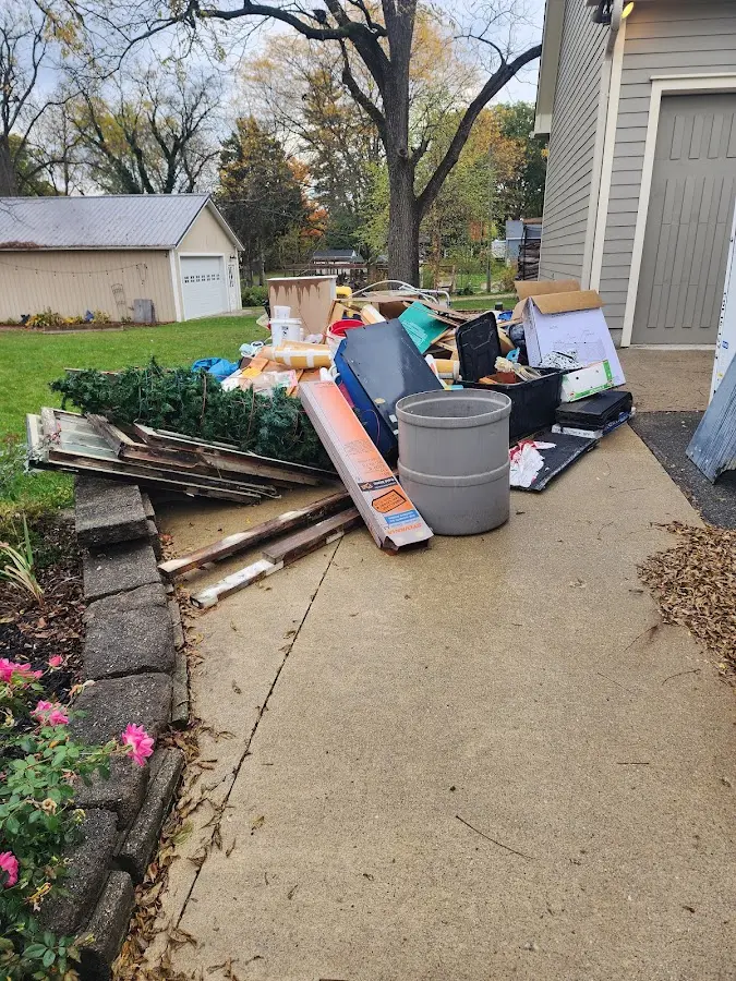 Dumpster being loaded with debris for Estate Cleanout Dumpster Rental in Provincetown